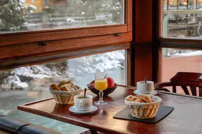 a bar in a room with wooden doors at Hôtel Vallée Blanche in Chamonix-Mont-Blanc