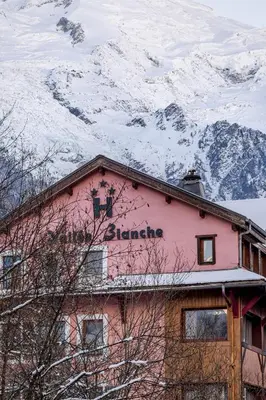 a table with two cups of coffee and some pastries and drinks at Hôtel Vallée Blanche in Chamonix-Mont-Blanc