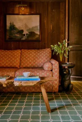 a living room with a couch and a table at Hôtel Saint-Georges Relais & Châteaux in Megève