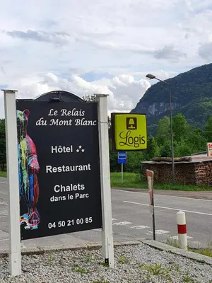 a sign for a hotel on the side of a road at Le Relais Du Mont Blanc in Magland