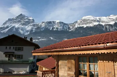 a house with a mountain in the background at Le Relais Du Mont Blanc in Magland