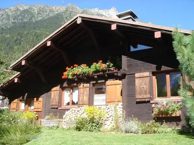 a house with flower boxes on the front of it at Chalet des Glaciers in Chamonix-Mont-Blanc