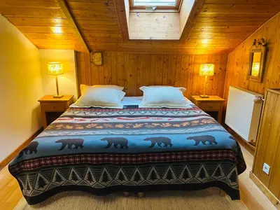a bedroom with a large bed in a cabin at Maison du Bourg in Samoëns