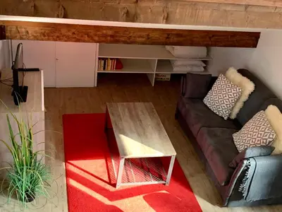 a living room with a couch and a table at Appartement Duplex Forclaz in Chamonix-Mont-Blanc