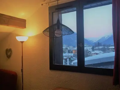 a room with a lamp and a window with a view at Appartement Duplex Forclaz in Chamonix-Mont-Blanc