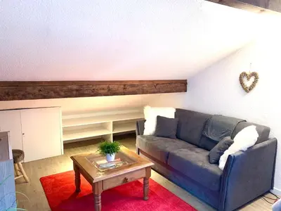 a living room with a couch and a table at Appartement Duplex Forclaz in Chamonix-Mont-Blanc