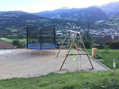 a playground with two swings and a swing at Chantemerle 1741, chambres d'hôtes à la montagne in Sallanches