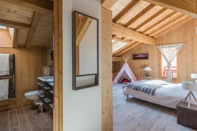 a bedroom with a bed and a tent at Chantemerle 1741, chambres d'hôtes à la montagne in Sallanches