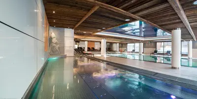a large swimming pool in a building with a pool at MGM Hôtels & Résidences - Résidence Le Cristal de Jade in Chamonix-Mont-Blanc
