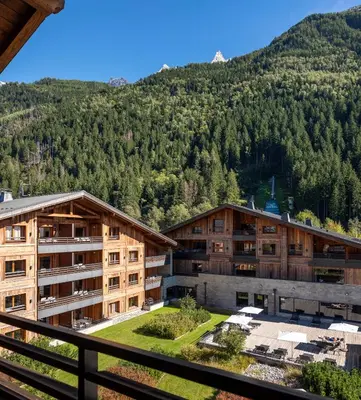 a lobby of a hotel with couches and a fireplace at MGM Hôtels & Résidences - Résidence Le Cristal de Jade in Chamonix-Mont-Blanc