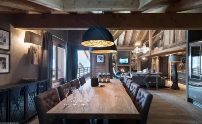 a bar with chairs and wine glasses on it at MGM Hôtels & Résidences - Résidence Le Cristal de Jade in Chamonix-Mont-Blanc