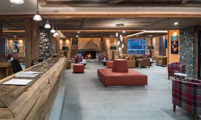 a bedroom with a large bed in a room with wooden walls at MGM Hôtels & Résidences - Résidence Le Cristal de Jade in Chamonix-Mont-Blanc