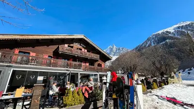 a group of people standing outside of a ski lodge at Hotel Le Castel in Chamonix-Mont-Blanc
