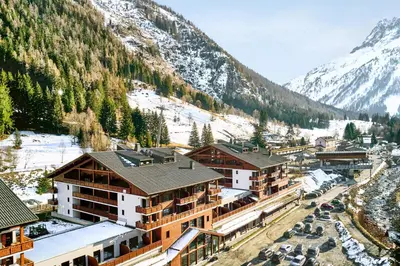 a woman riding a bike in the mountains at Dormio Resort Les Portes du Mont Blanc in Vallorcine