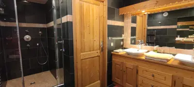 a bathroom with two sinks and a shower at Chalet KIDOU, Grand Confort, nouveau SPA extérieur in Chamonix-Mont-Blanc