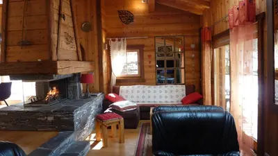a living room with a fireplace and a couch at Chalet KIDOU, Grand Confort, nouveau SPA extérieur in Chamonix-Mont-Blanc