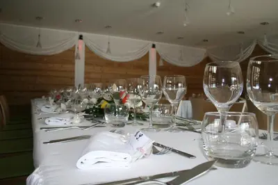 a table with wine glasses and napkins on it at La Croix de Savoie & Spa in Les Carroz d'Araches