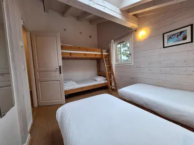 two beds in a small room with two bunk beds at Chalet Hideaway 2 in Chamonix-Mont-Blanc