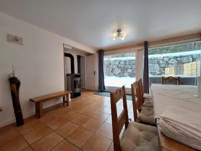 a living room with a table and a fireplace at Chalet Hideaway 2 in Chamonix-Mont-Blanc