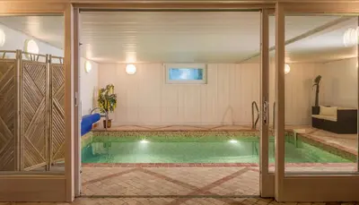 a swimming pool in a house with an open door at Chalet Hideaway 2 in Chamonix-Mont-Blanc