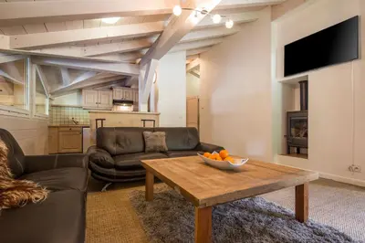 a living room with a couch and a table at Chalet Hideaway 2 in Chamonix-Mont-Blanc
