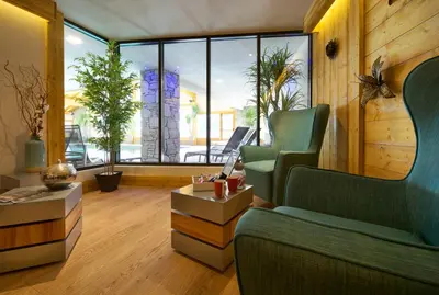 a living room with two chairs and a table at CGH Résidence Boutique Les Chalets de Léana in Les Carroz d'Araches