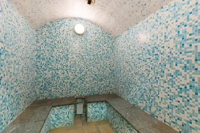 a bathroom with blue and white tiled walls at Residence Les Fermes du Soleil - maeva Home in Les Carroz d'Araches