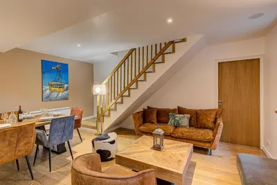 a living room with a couch and a table at APARTMENT BIOLAY - Alpes Travel - Central Chamonix - Sleeps 6 in Chamonix-Mont-Blanc
