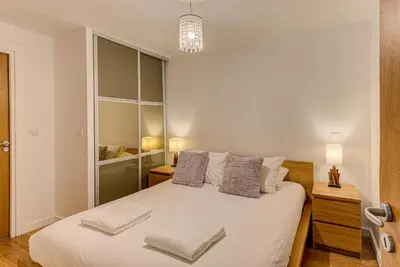 a bedroom with a large white bed with two pillows at APARTMENT BIOLAY - Alpes Travel - Central Chamonix - Sleeps 6 in Chamonix-Mont-Blanc