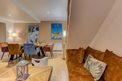 a living room with a couch and a table at APARTMENT BIOLAY - Alpes Travel - Central Chamonix - Sleeps 6 in Chamonix-Mont-Blanc