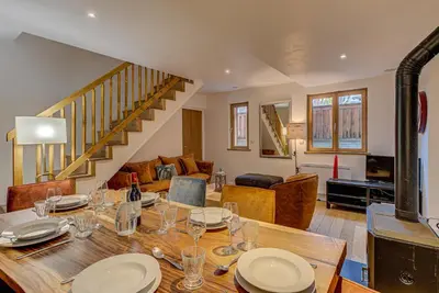 a dining room with a table and a living room at APARTMENT BIOLAY - Alpes Travel - Central Chamonix - Sleeps 6 in Chamonix-Mont-Blanc