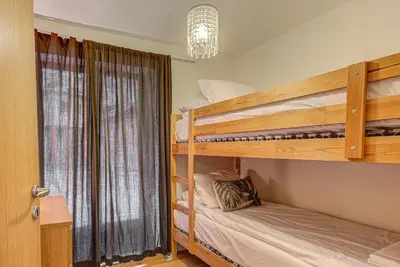 a bedroom with two bunk beds and a window at APARTMENT BIOLAY - Alpes Travel - Central Chamonix - Sleeps 6 in Chamonix-Mont-Blanc