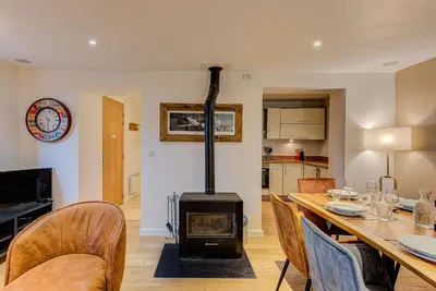 a living room with a wood stove in a dining room at APARTMENT BIOLAY - Alpes Travel - Central Chamonix - Sleeps 6 in Chamonix-Mont-Blanc