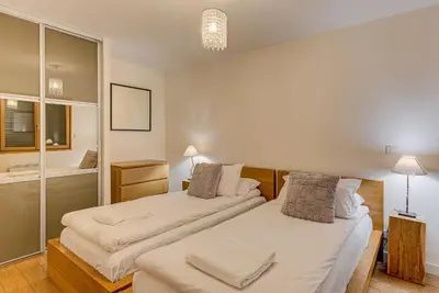 a bedroom with two beds and a bathroom at APARTMENT BIOLAY - Alpes Travel - Central Chamonix - Sleeps 6 in Chamonix-Mont-Blanc