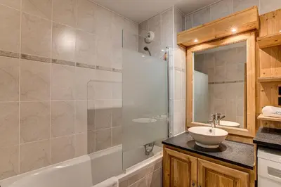 a bathroom with a tub and a sink and a shower at APARTMENT STADDON - Alpes Travel - Central Chamonix - Sleeps 4-6 in Chamonix-Mont-Blanc