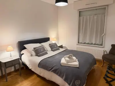 a bedroom with a bed with a towel on it at Appartement CITY CENTER-SALLANCHES in Sallanches