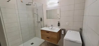 a bathroom with a toilet and a sink and a shower at Appartement CITY CENTER-SALLANCHES in Sallanches