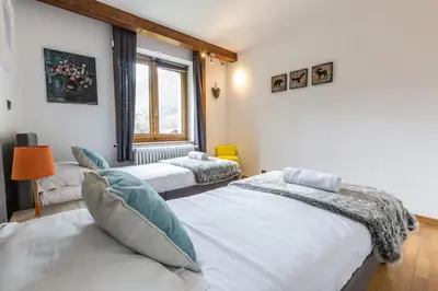 a bedroom with two beds and a window at Apartment Germain Close to Chamonix Mont Blanc in Chamonix-Mont-Blanc