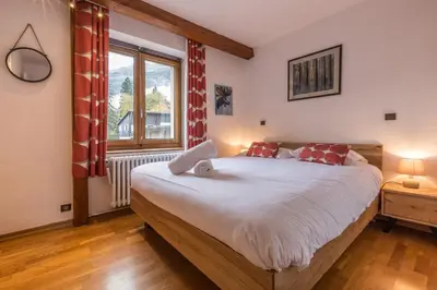 a bedroom with a large bed and a window at Apartment Germain Close to Chamonix Mont Blanc in Chamonix-Mont-Blanc