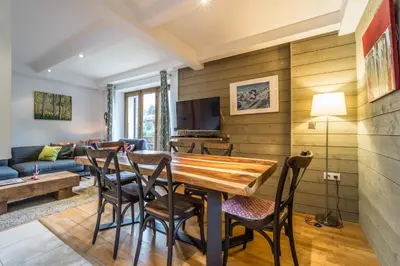 a living room with a table and chairs and a couch at Apartment Germain Close to Chamonix Mont Blanc in Chamonix-Mont-Blanc