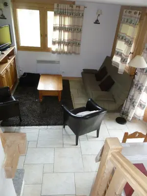 a living room with a couch and a chair at Chalets de Julie in Megève