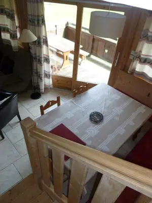 a table in a room with a view of a patio at Chalets de Julie in Megève