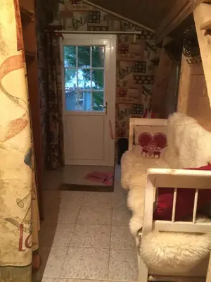 a room with a door and a couch and a window at chalet des petits loups in Chamonix-Mont-Blanc