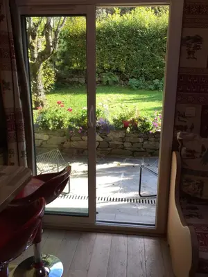 an open door with a view of a yard at chalet des petits loups in Chamonix-Mont-Blanc