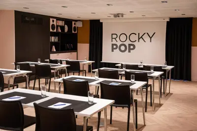 a restaurant with tables and chairs and a rocky pop sign at RockyPop Chamonix - Les Houches in Les Houches
