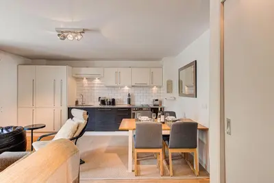a kitchen and dining room with a table and chairs at APARTMENT COSMIQUES - Alpes Travel - Central Chamonix - Sleeps 4 in Chamonix-Mont-Blanc