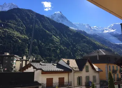 a view of a mountain range with houses and mountains at La Chabane in Chamonix-Mont-Blanc