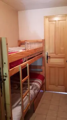 two bunk beds in a room with a door at La Coupe De Cristal in Saint-Gervais-les-Bains