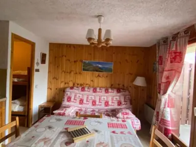 a bedroom with a bed and a table in it at La Coupe De Cristal in Saint-Gervais-les-Bains