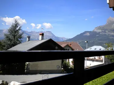 a view of a house with mountains in the background at La Coupe De Cristal in Saint-Gervais-les-Bains